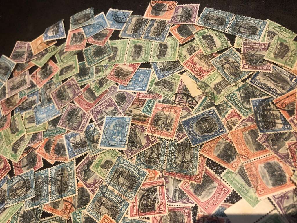 A COUPLE THOUSAND   MOZAMBIQUE   STAMPS OFF PAPER