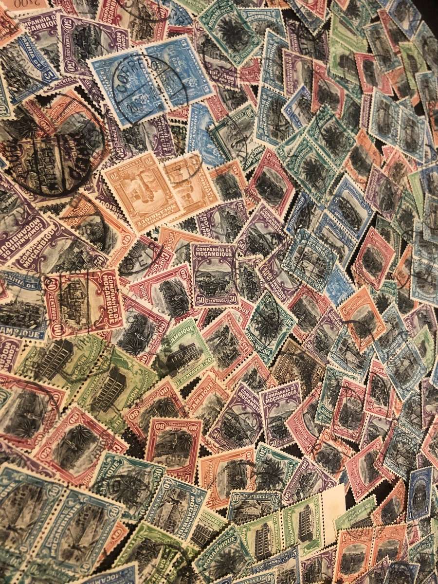 A COUPLE THOUSAND   MOZAMBIQUE   STAMPS OFF PAPER