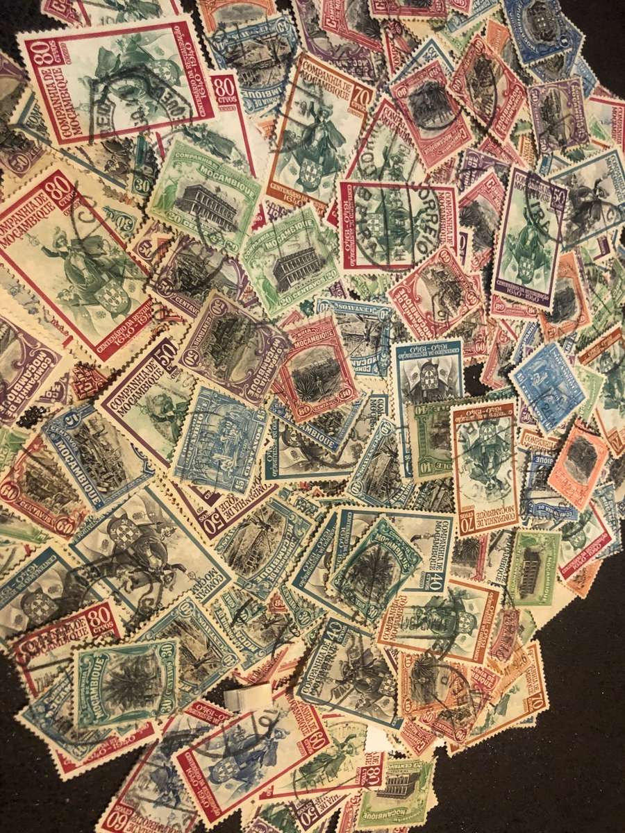 A COUPLE THOUSAND   MOZAMBIQUE   STAMPS OFF PAPER