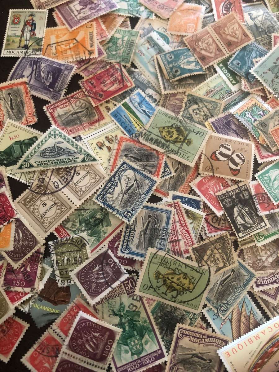 A COUPLE THOUSAND   MOZAMBIQUE   STAMPS OFF PAPER