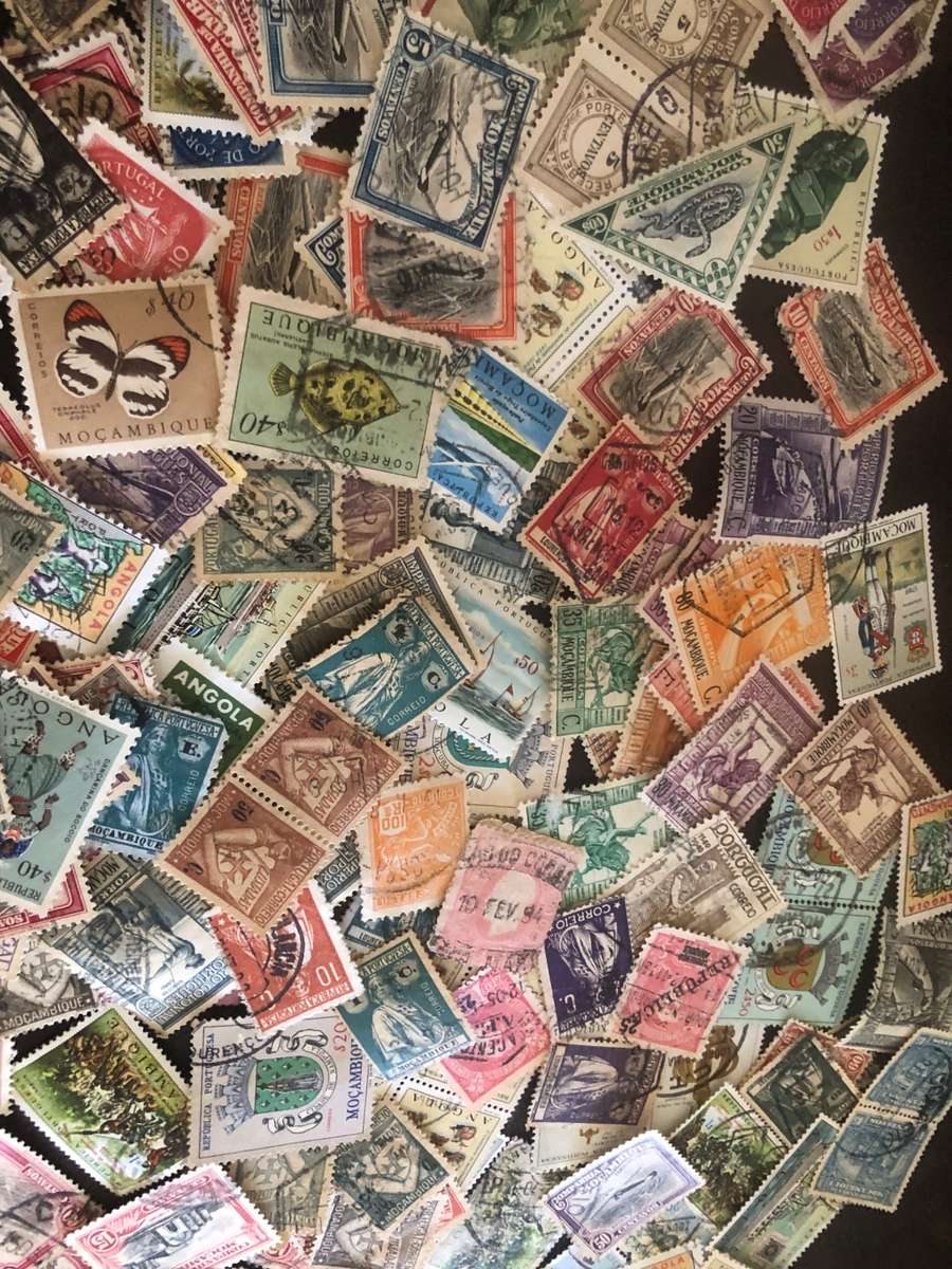 A COUPLE THOUSAND   MOZAMBIQUE   STAMPS OFF PAPER