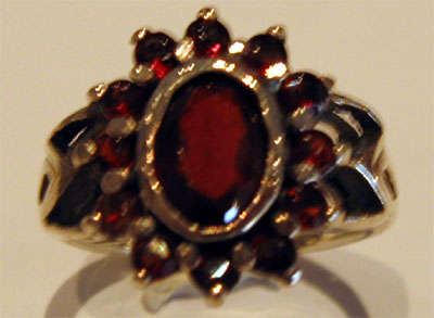 Silver "Lady Di" styled ring set with Garnets