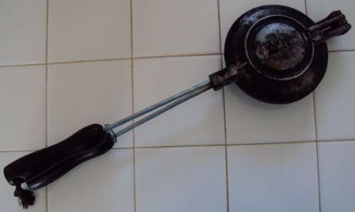 A much used jaffle waffle maker with wooden handles
