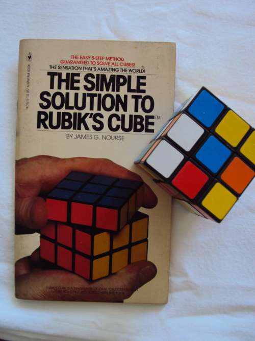A Rubik's Cube plus a vintage book THE SIMPLE SOLUTION TO RUBIK'S CUBE