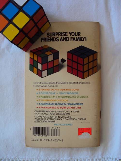 A Rubik's Cube plus a vintage book THE SIMPLE SOLUTION TO RUBIK'S CUBE