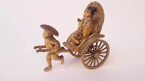 Oriental man pulling a rickshaw with woman - amazing detail