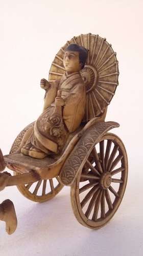 Oriental man pulling a rickshaw with woman - amazing detail