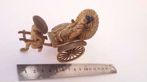 Oriental man pulling a rickshaw with woman - amazing detail