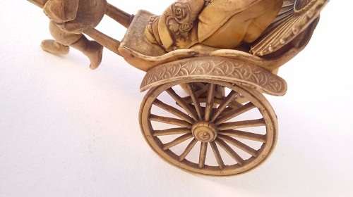 Oriental man pulling a rickshaw with woman - amazing detail