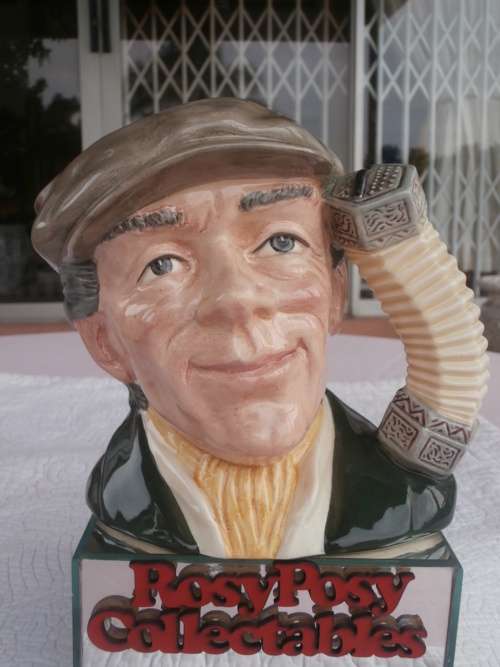 LARGE Royal Doulton Character Jug, The Busker D6775 (grey cap, green coat, yellow scarf). mint 15cm
