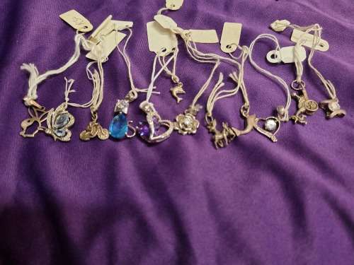 Assorted silver pendants and small silver charms