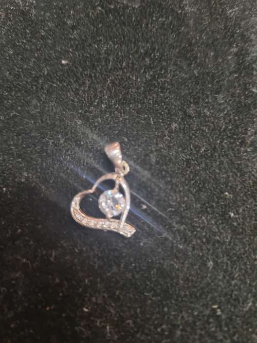 Assorted silver pendants and small silver charms