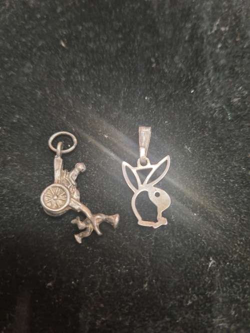 Assorted silver pendants and small silver charms