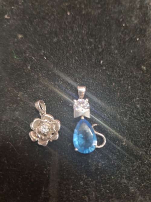 Assorted silver pendants and small silver charms