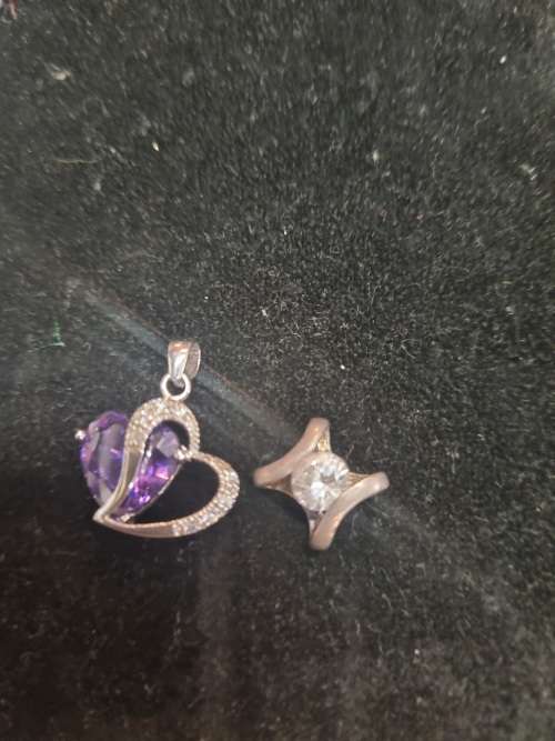 Assorted silver pendants and small silver charms