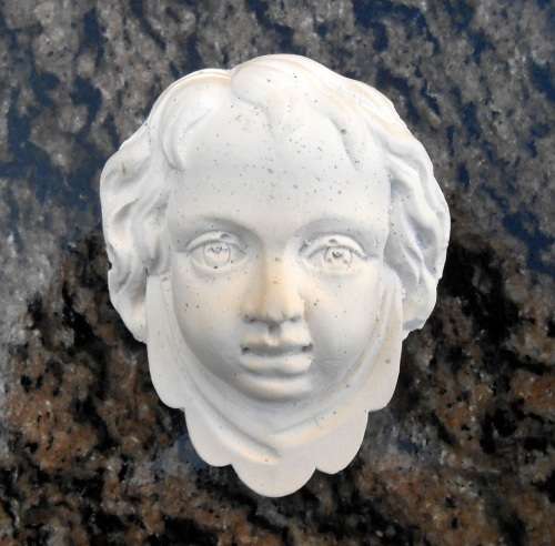 Antique style plaque of Baby Face