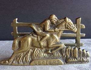 A very old solid brass letter holder