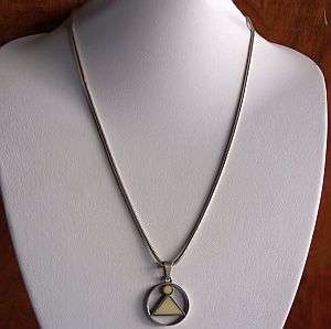 A STERLING SILVER NECKLACE WITH A STERLING SILVER PENDANT DECORATED WITH EITHER IVORY OR BONE
