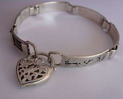 A SOLID STERLING SILVER BRACELET WITH WILDLIFE MOTIFS AND PADLOCK CLASP - A TRUE LA COCK ORIGINAL