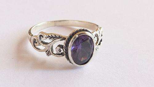 AN OUTSTANDING SOLID STERLING SILVER RING SET WITH A LOVELY FACETED PURPLE STONE ...MUST HAVE !!