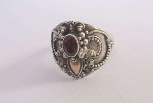 A GORGEOUS SOLID STERLING SILVER RING SET WITH A FACETED GARNET AND GOLD ACCENT....WOW..WOW..WOW !!!