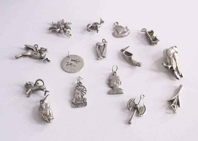 A REMARKABLE COLLECTION OF 15 SILVER CHARMS...VARIOUS PURITY....DESIGNER PIECES...BID FOR THE LOT !!