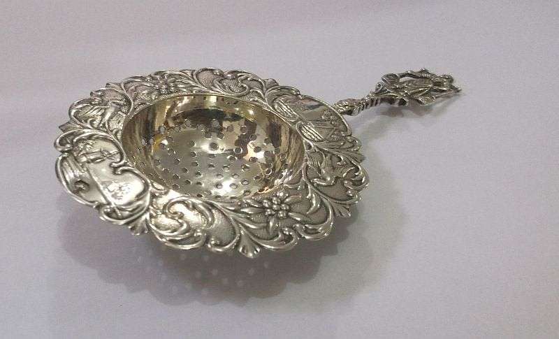 An old solid Dutch silver tea strainer with beautiful detail and applicable stamps