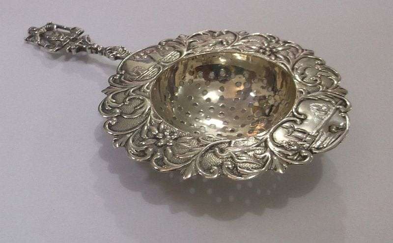 An old solid Dutch silver tea strainer with beautiful detail and applicable stamps