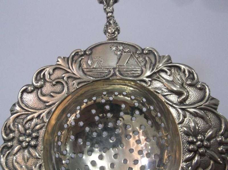 An old solid Dutch silver tea strainer with beautiful detail and applicable stamps