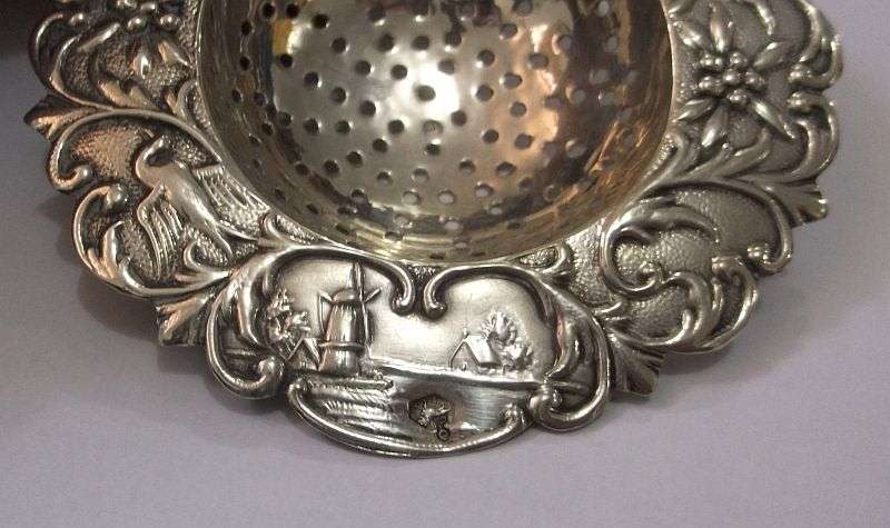 An old solid Dutch silver tea strainer with beautiful detail and applicable stamps