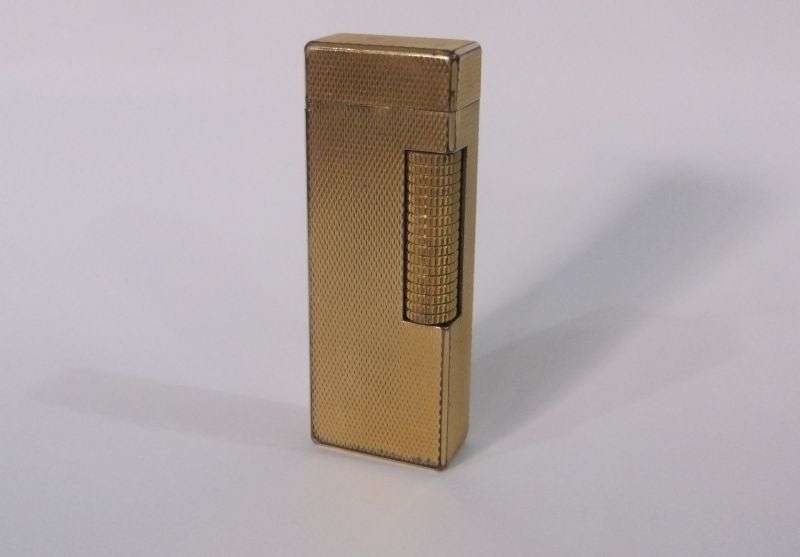 A totally Cool Vintage Swiss made gold plated lighter by Dunhill .....Sparking !!!!