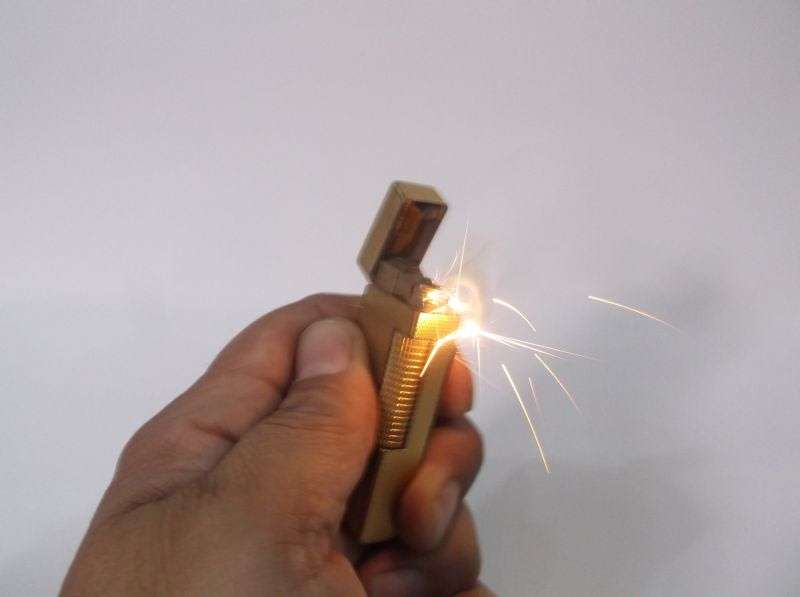 A totally Cool Vintage Swiss made gold plated lighter by Dunhill .....Sparking !!!!