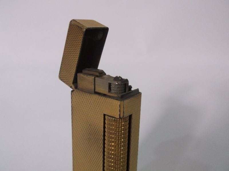 A totally Cool Vintage Swiss made gold plated lighter by Dunhill .....Sparking !!!!
