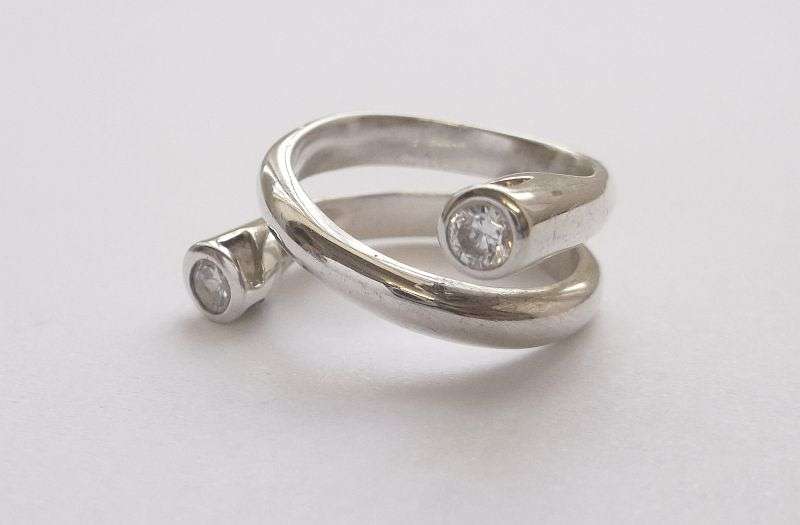 An Elegant and excellent Quality solid Sterling Silver ring ....with a TWIST ...and faceted Stones