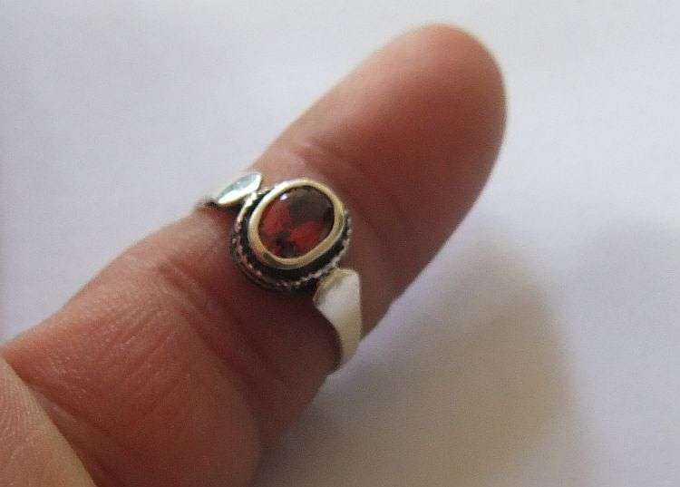 A Fancy Solid Sterling Silver ring set with a red faceted Cubic Zirconia !! No Combining Fees !!