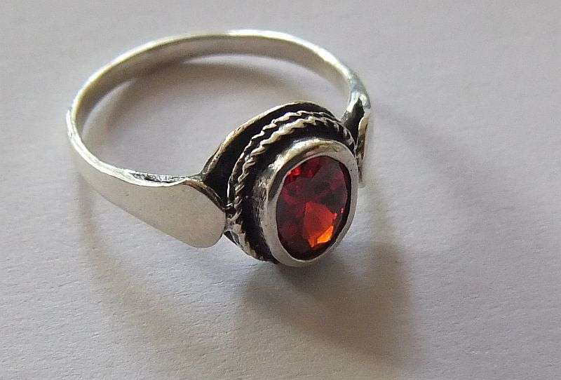 A Fancy Solid Sterling Silver ring set with a red faceted Cubic Zirconia !! No Combining Fees !!