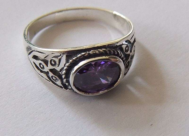 A Great Quality Solid Sterling Silver ring set with an Amethyst colored Cubic Zirconia !! WoW !!