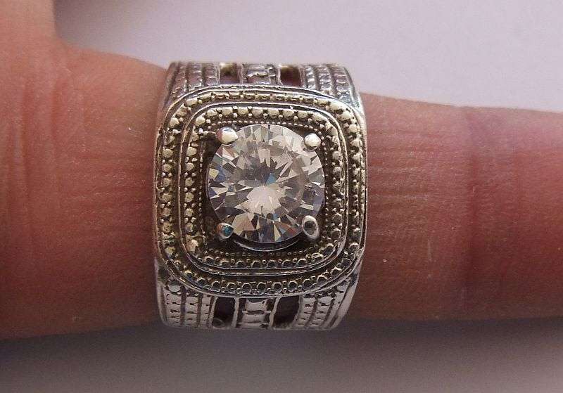 A GREAT QUALITY BIG , BOLD , BEAUTIFUL SOLID STERLING SILVER RING SET WITH A BIG FACETED CZ STONE