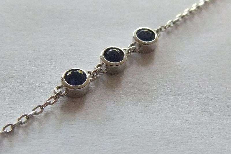 A PETITE YET ELEGANT SOLID STERLING SILVER BRACELET SET WITH 3 FACETED BLUE STONES !! BRAND NEW !!