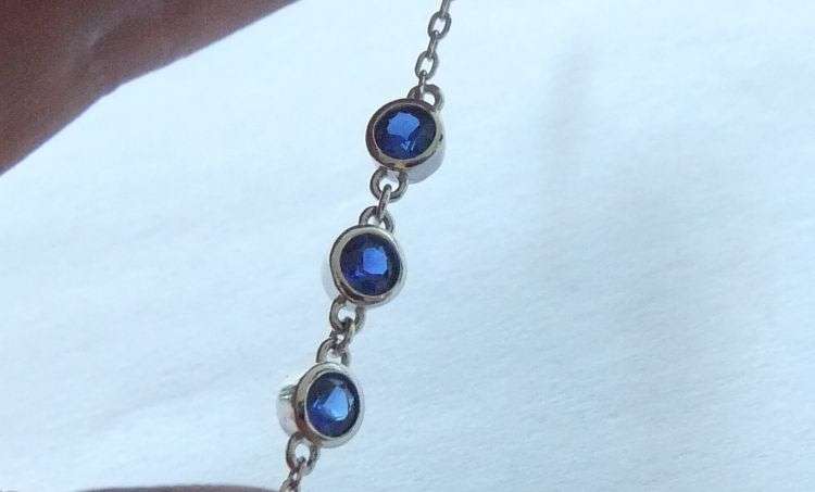 A PETITE YET ELEGANT SOLID STERLING SILVER BRACELET SET WITH 3 FACETED BLUE STONES !! BRAND NEW !!