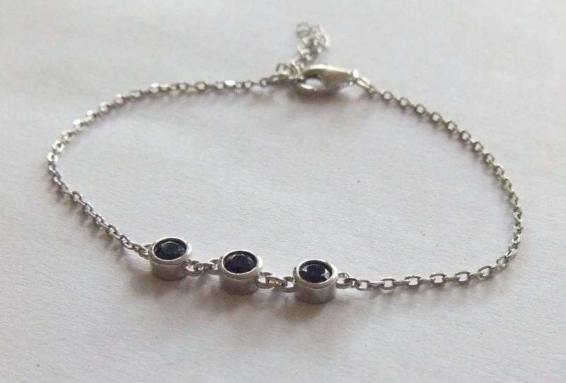 A PETITE YET ELEGANT SOLID STERLING SILVER BRACELET SET WITH 3 FACETED BLUE STONES !! BRAND NEW !!