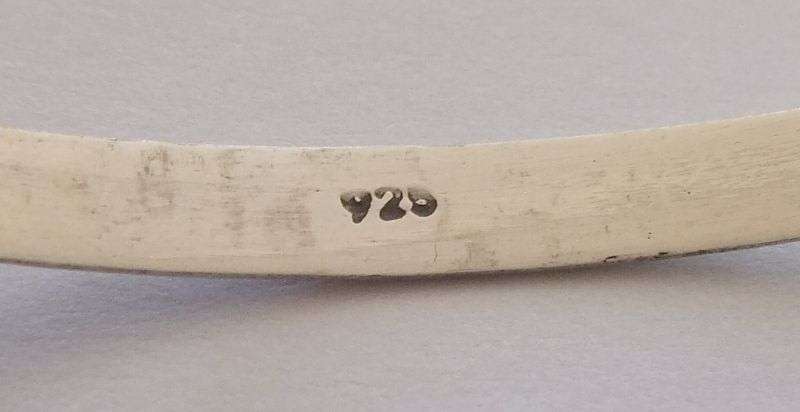 A SOLID STERLING SILVER BANGLE