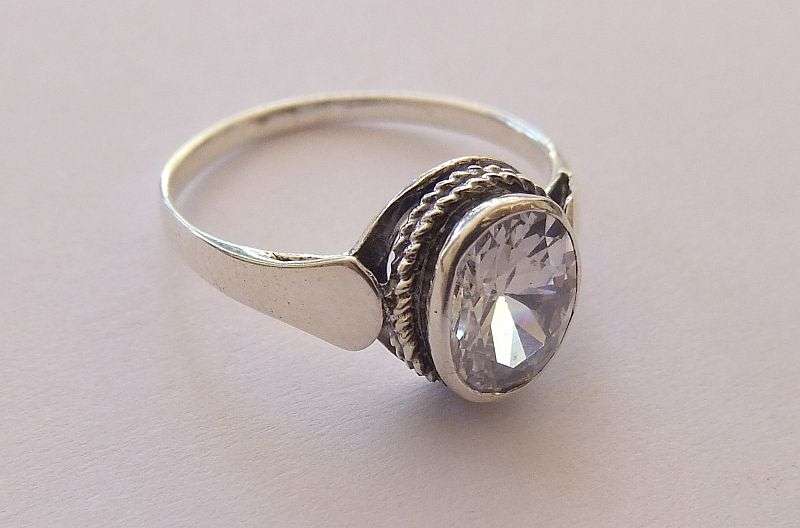 AN EYE CATCHING SOLID STERLING SILVER RING SET WITH A SPARKLY FACETED STONE !! NEVER WORN ...