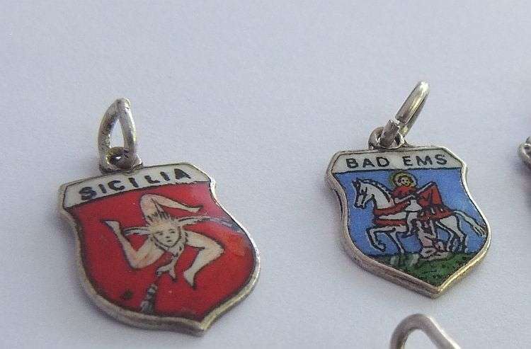 A LOT OF 9 VINTAGE SILVER AND STERLING SILVER CHARMS ...ENAMEL , TEDDY , CUFFS , HEART AND MORE !!