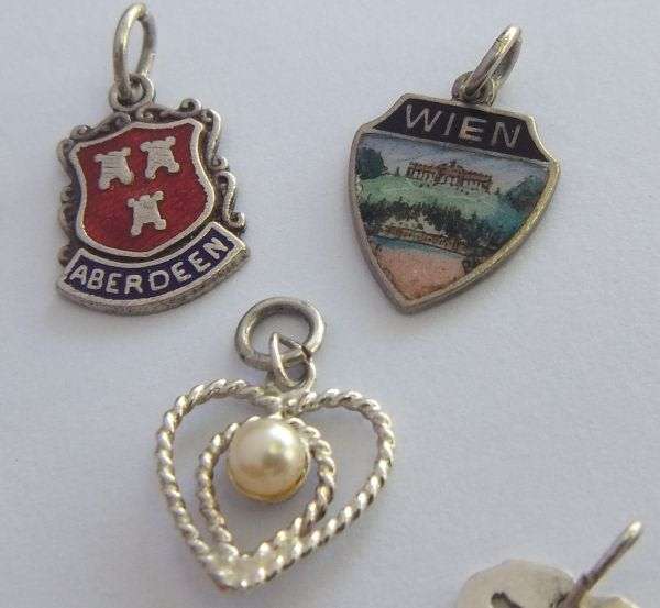 A LOT OF 9 VINTAGE SILVER AND STERLING SILVER CHARMS ...ENAMEL , TEDDY , CUFFS , HEART AND MORE !!