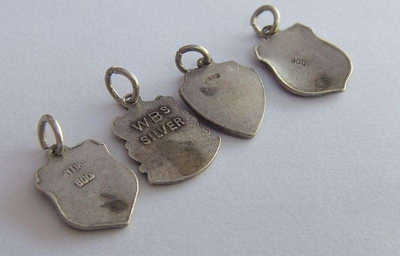 A LOT OF 9 VINTAGE SILVER AND STERLING SILVER CHARMS ...ENAMEL , TEDDY , CUFFS , HEART AND MORE !!
