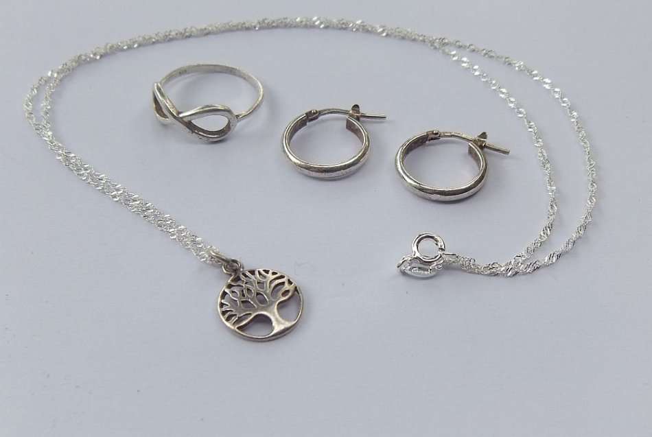 WHAT MORE !! A STERLING SILVER NECKLACE WITH TREE OF LIFE , AN ETERNITY RING PLUS SILVER EARRINGS !!