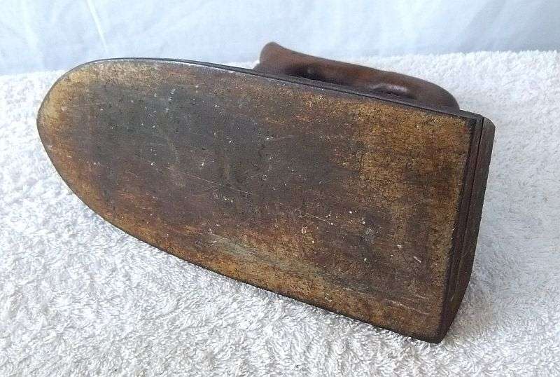 WHAT`S THIS ? A VERY VERY OLD IRON ...SAD IRON ? LOOKS TO HAVE ELECTRICAL CONNECTORS ...MMMM..