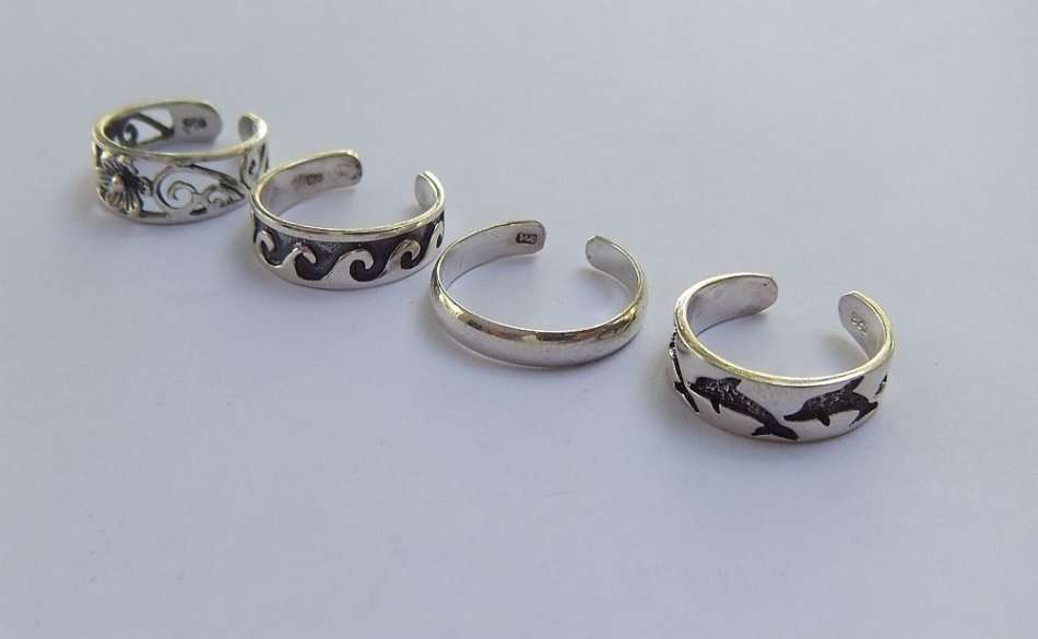 AS NEW !! FOUR SOLID STERLING SILVER TOE RINGS !! 4 DIFFERENT DESIGNS !! BID FOR ALL !! NEVER WORN !