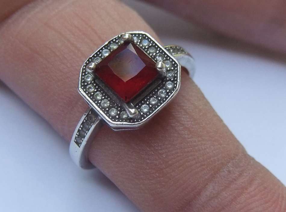 AN ELEGANT VINTAGE STYLE SOLID STERLING SILVER RING SET WITH A FACETED RED STONE AND MORE !! WOW !!